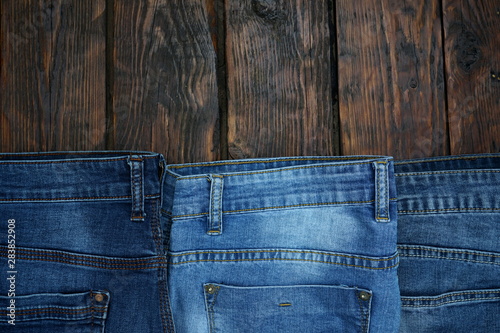 blue jeans on dark wooden background
