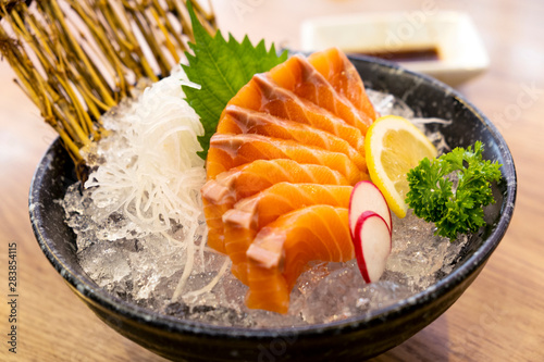 Sashimi salmon on ice in a bowl in a restaurant