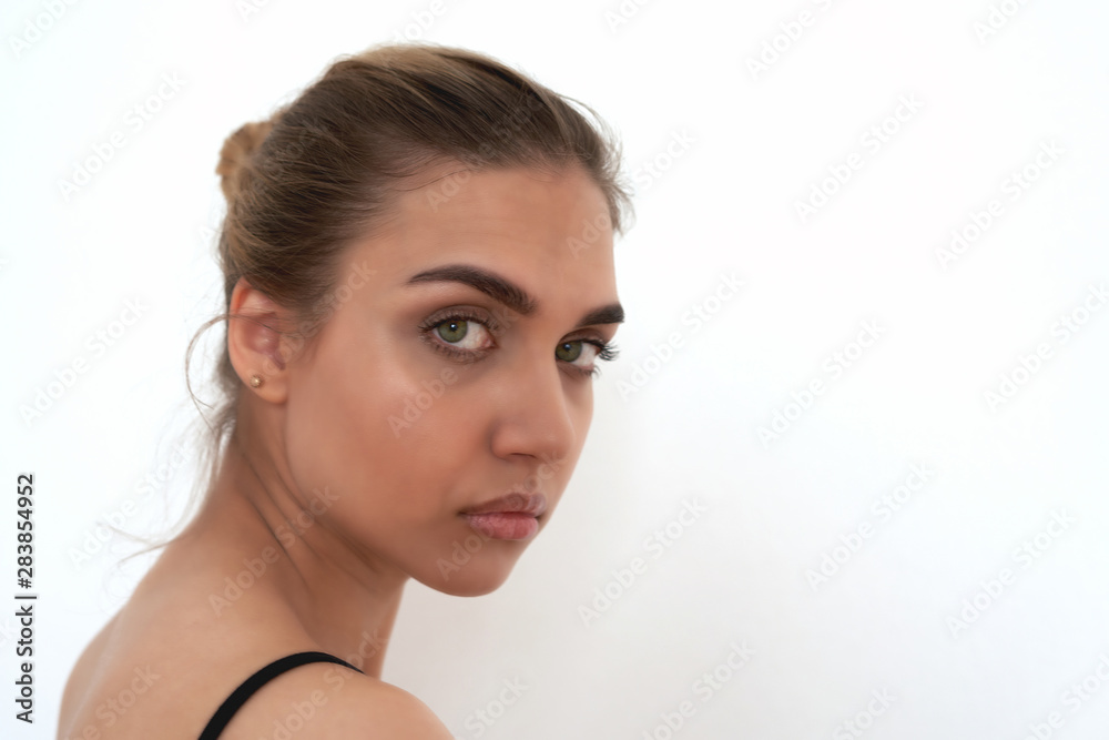 Closeup portrait of a beautiful young blonde with green eyes, white background Closeup portrait of a beautiful young blonde with green eyes, white background