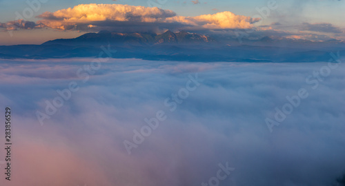Mountains emerging from a sea of clouds at sunrise-Tatra Mountains, Poland