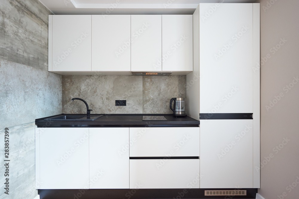 white minimalist kitchen with black countertop and sink white minimalist kitchen with black countertop and sink