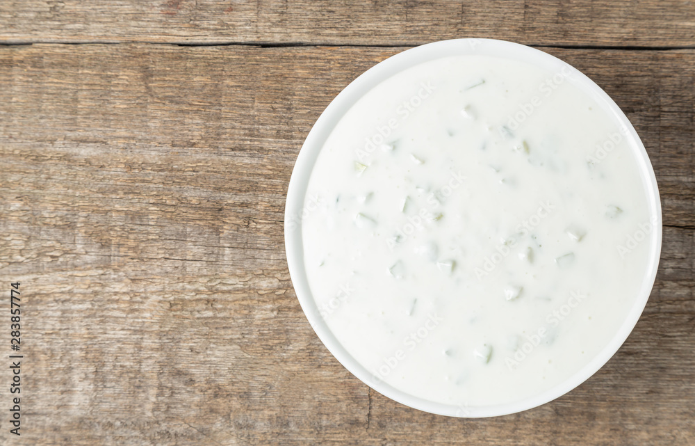 Tzatziki sauce made of yogurt, cucumbers, garlic and olive oil. National Greek cuisine. The view from the top. Copy space.