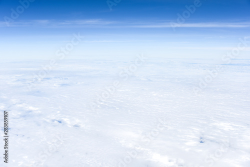 Background of View the blue sky and white clouds from the airplane window with copy space