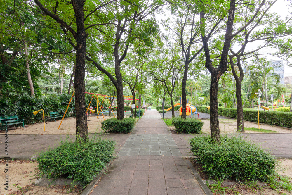 Playground walkways surrounded by green trees