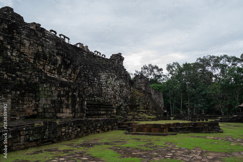Many neglected rocks from the temple in Angkor, Siem Reap, Cambodia under a cloudy sky - World Heritage by UNESCO in 1992