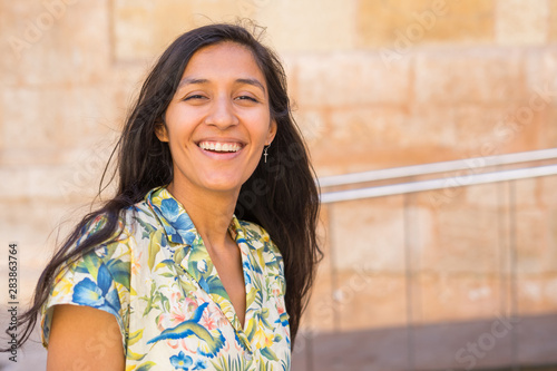 Young indian woman laughing in the street