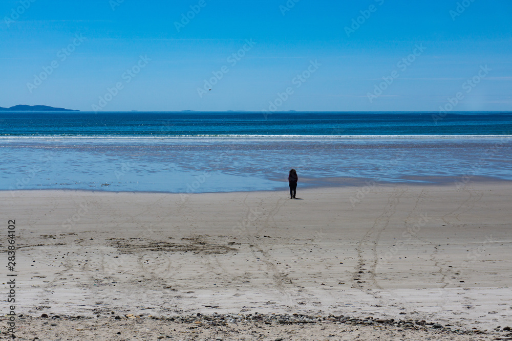 a solitary person in Keel Beach, Achill Island, County Mayo, Ireland