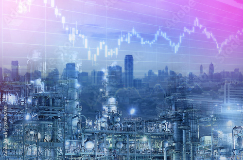 Industry business background. Oil refinery with city and graphice stock chart multiple exposure.