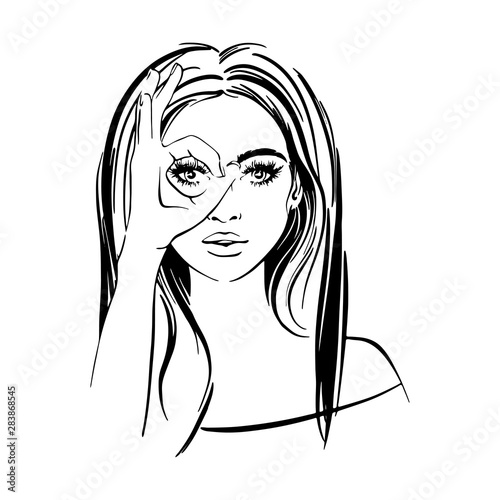 Beautifull woman with long dark hair, with crossed her fingers and looks like through binoculars
