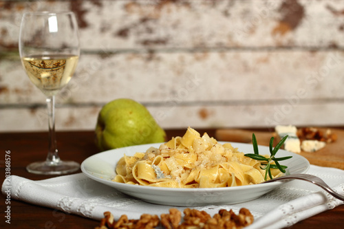 Pappardelle al Gorgonzola. Pasta (Fettuccine) with gorgonzola, pear, walnuts and white wine.