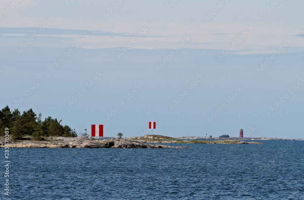 A red white sea marks standing on a cliff at Bothnian sea 