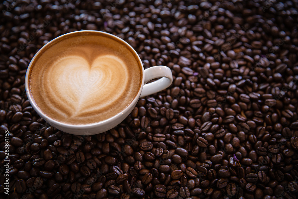 cup of coffee and coffee beans on dark background, top view cup of coffee and coffee beans on dark background, top view