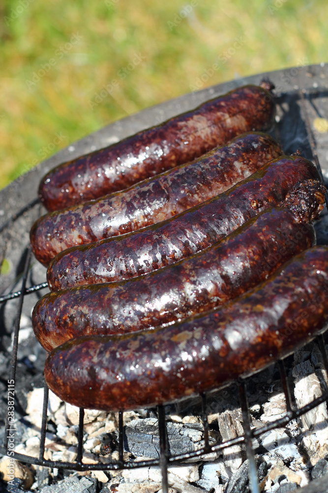 Grilling Blood Sausages on barbecue grill
