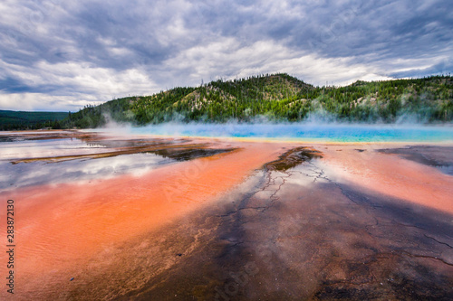 Grand Prismatic Spring under dramatic sky in Yellowstone