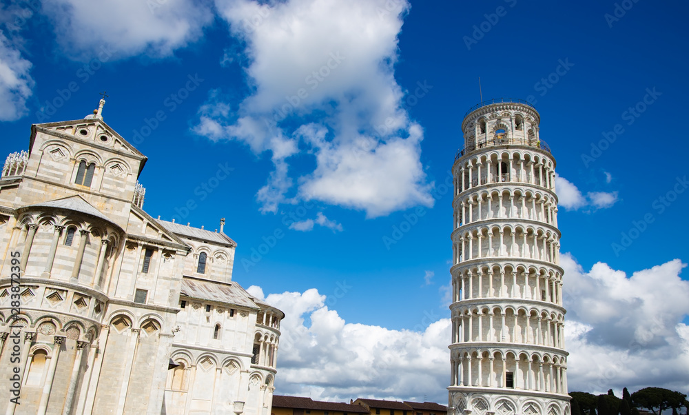 Beautiful view of Cloudy blue sky in Pisa Cathedral (Duomo di Pisa) with Leaning Tower  (Torre di Pisa) Tuscany, Italy.The Leaning Tower of Pisa is one of the main landmark in Italy.