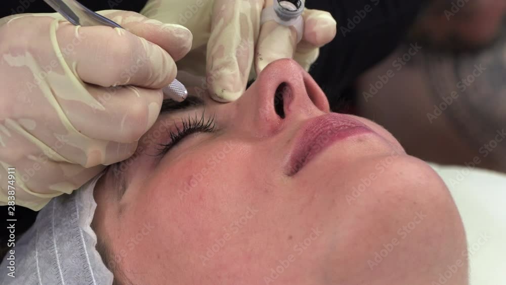 Young girl doing microblading procedure