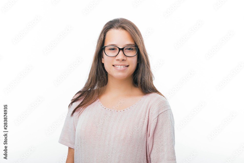 Portrait of young woman, wearing glasses, looking at camera standing over white background Portrait of young woman, wearing glasses, looking at camera standing over white background