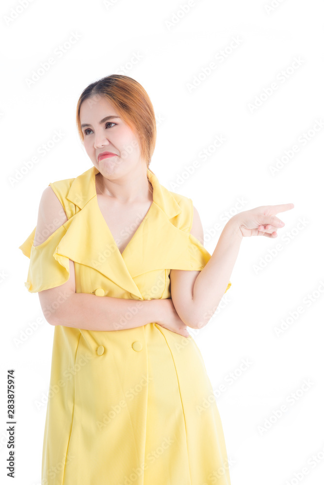 Asian girl in yellow dress Showing facial expressions to disregard certain things with pointing your fingers toward that on the White Blackground Asian girl in yellow dress Showing facial expressions to disregard certain things with pointing your fingers toward that on the White Blackground