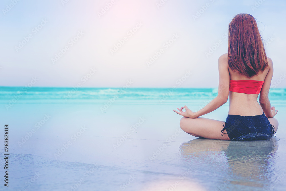 Young woman doing practice yoga on the sea beach at sunset Young woman doing practice yoga on the sea beach at sunset