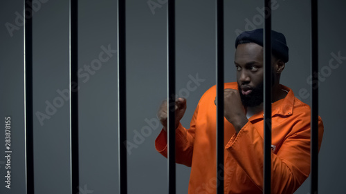 African-american male prisoner preparing to box in cell with inmate, quarrel