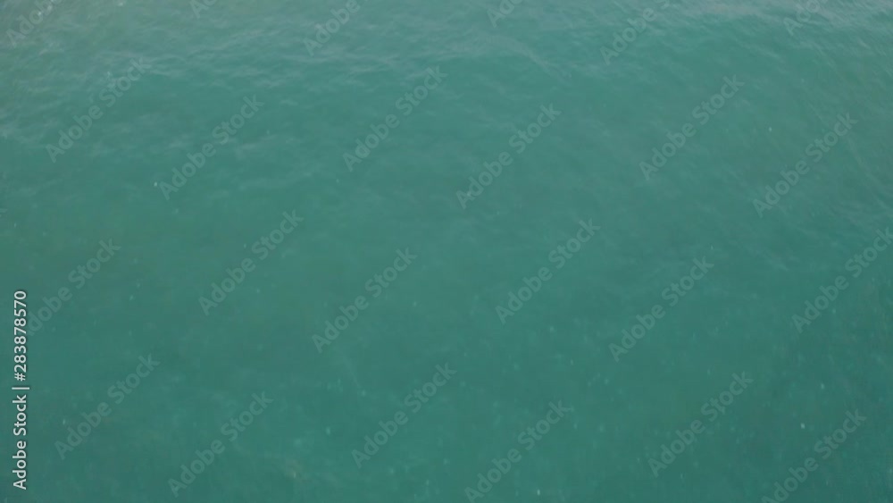 A bird view shot of a beach near a promenade A bird view shot of a beach near a promenade
