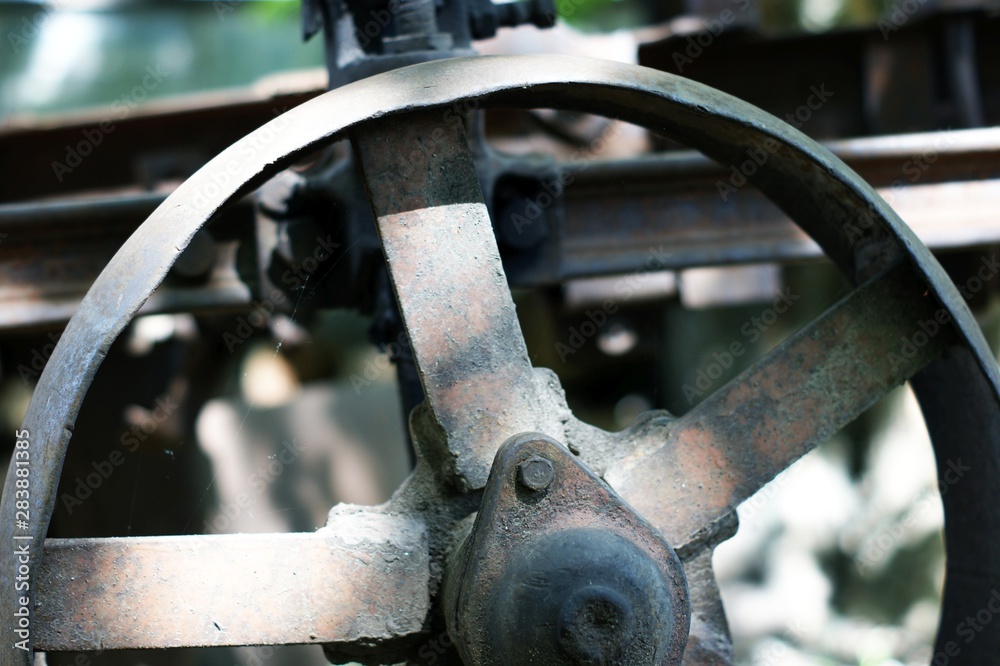 Old rusty plow, details against the background of firewood. Old rusty plow, details against the background of firewood.