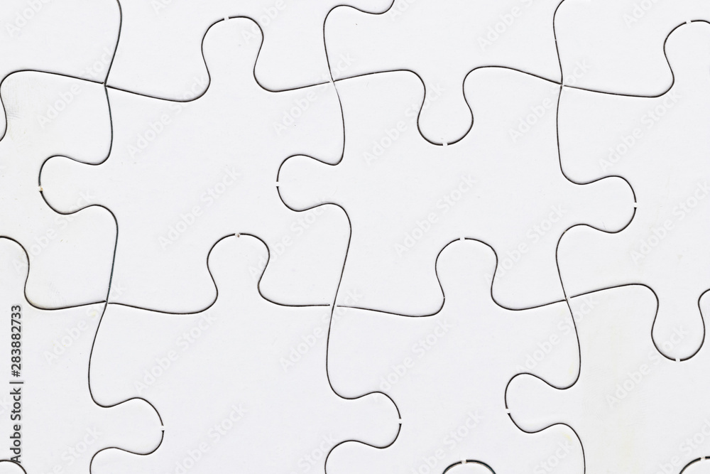 Close-up of white jigsaw puzzle grid background Close-up of white jigsaw puzzle grid background