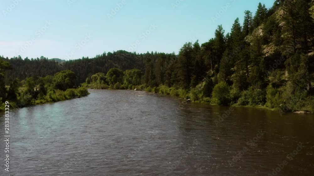 Aerial view along a wide river running through a valley of trees. Bennett Peak, North Platte River, Wyoming, USA | 4K Aerial view along a wide river running through a valley of trees. Bennett Peak, North Platte River, Wyoming, USA | 4K