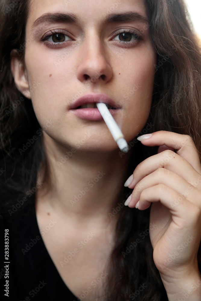 Closeup portrait of long haired curly beautiful girl. With cigarete .Smoking. Closeup portrait of long haired curly beautiful girl. With cigarete .Smoking.
