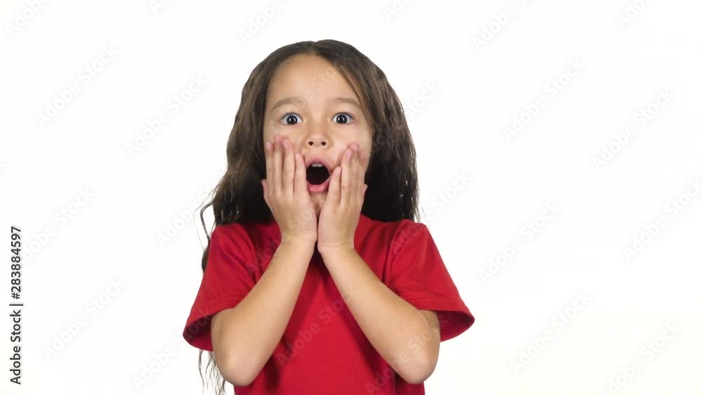 Kid posing surprisingly on white background. Slow motion Kid posing surprisingly on white background. Slow motion