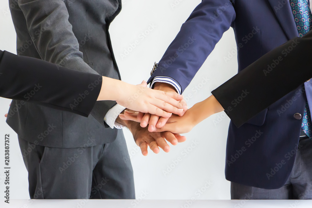 Businessmen are laying hands together in layers. Concept, cooperation and unity in work Businessmen are laying hands together in layers. Concept, cooperation and unity in work
