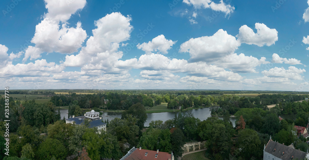 Panorama of cloudy sky over park landscape