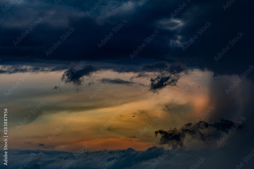 Beautiful sunset sky. Orange, blue, and white sky. Colorful sunrise. Art picture of sky at sunrise. Sunrise and clouds for inspiration background. Nature background. Peaceful and tranquil concept.
