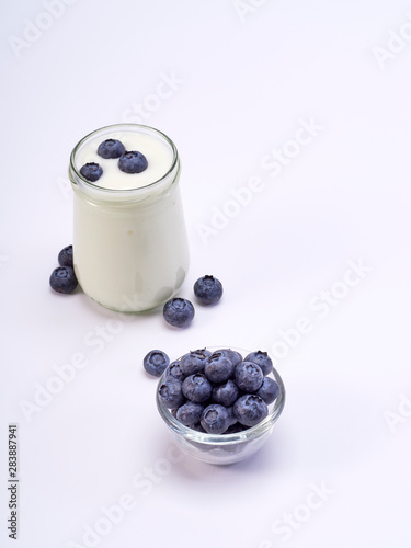 Fresh blueberry yogurt glass on a white background