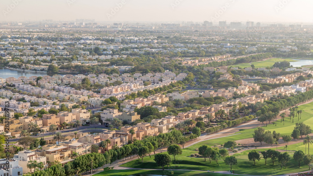 Aerial view to villas and houses with Golf course with green lawn and lakes timelapse