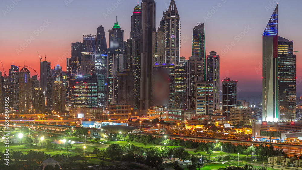 Fototapeta premium Dubai Marina skyscrapers and golf course day to night timelapse, Dubai, United Arab Emirates