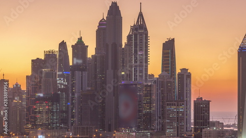 Dubai Marina skyscrapers and golf course day to night timelapse  Dubai  United Arab Emirates