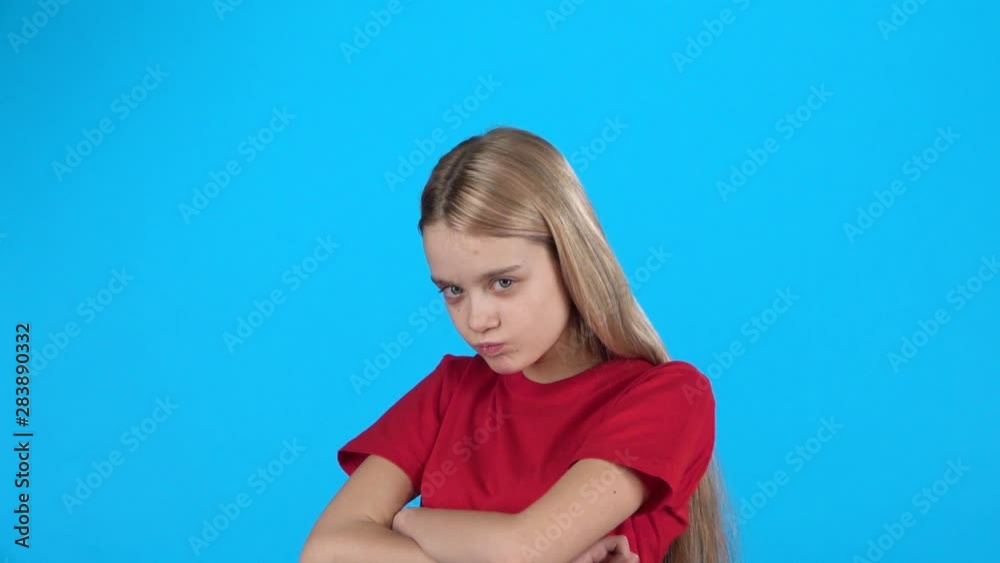 Little blonde-haired girl stands upset and waves her head negatively, slow motion Little blonde-haired girl stands upset and waves her head negatively, slow motion
