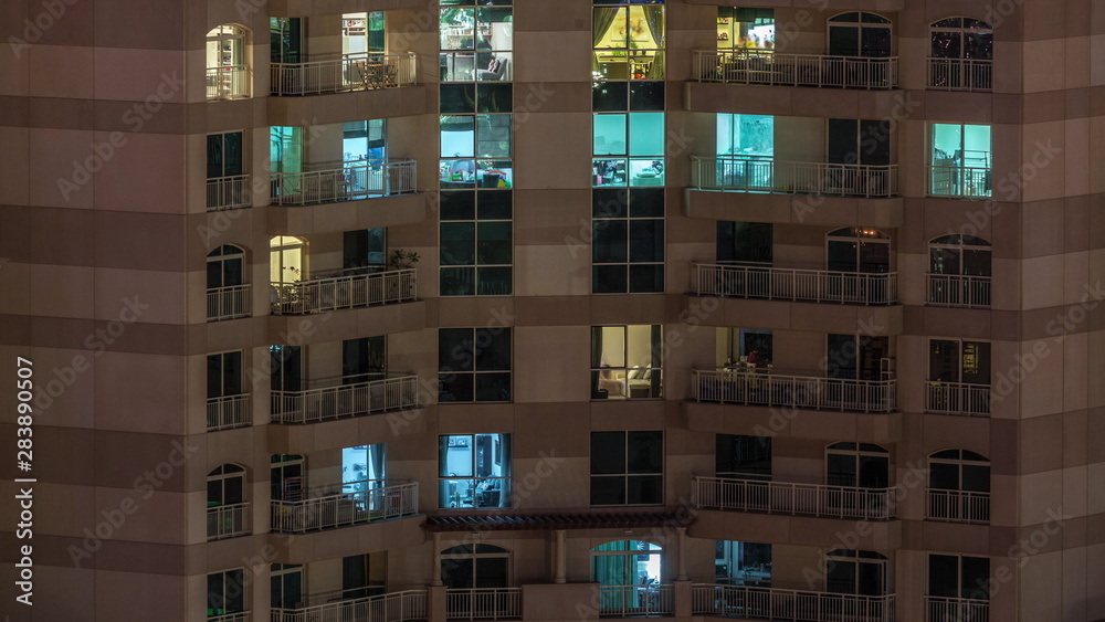 Windows of the multi-storey building with lighting inside and moving people in apartments timelapse. Windows of the multi-storey building with lighting inside and moving people in apartments timelapse.