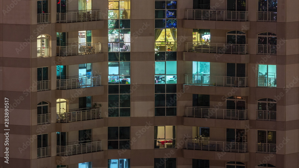 Windows of the multi-storey building with lighting inside and moving people in apartments timelapse. Windows of the multi-storey building with lighting inside and moving people in apartments timelapse.