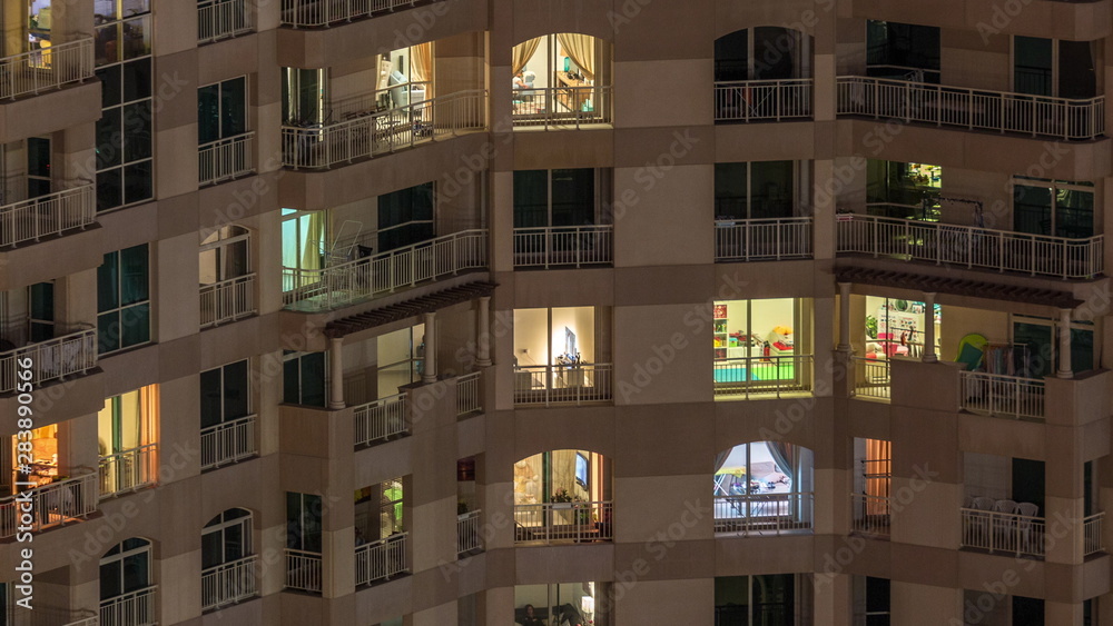 Windows of the multi-storey building with lighting inside and moving people in apartments timelapse. Windows of the multi-storey building with lighting inside and moving people in apartments timelapse.
