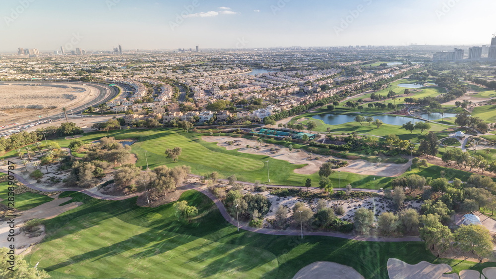 Golf course and Jumeirah lake towers skyscrapers before sunset timelapse,, Dubai, United Arab Emirates