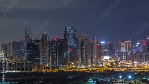 Jumeirah lake towers and Dubai marina skyscrapers and golf course during all night timelapse  Dubai  United Arab Emirates