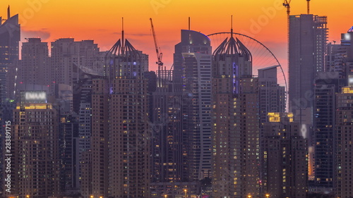 Dubai Marina skyscrapers and golf course day to night timelapse, Dubai, United Arab Emirates
