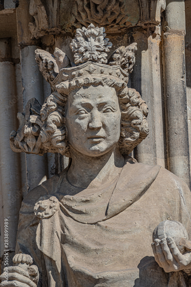 Wall figure of the queen at main facade of catholic cathedral in Magdeburg, Germany, closeup, details