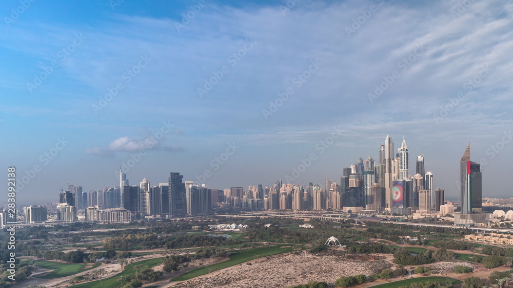 Fototapeta premium Dubai Marina skyscrapers and golf course morning timelapse, Dubai, United Arab Emirates