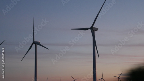 sunset over electric windmills