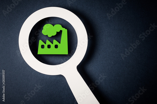 Checking factory with magnifying glass
