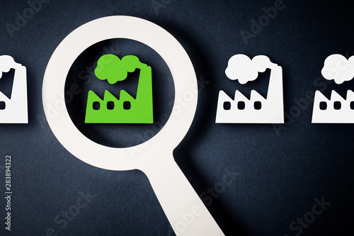 Checking factory with magnifying glass