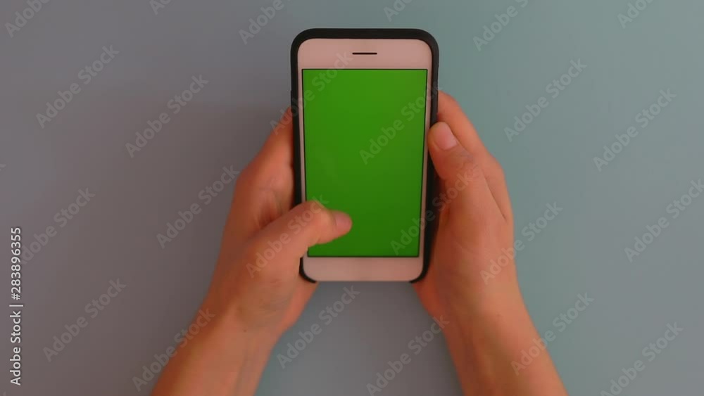 Woman hands use smartphone with green screen on blue background 5g technology Woman hands use smartphone with green screen on blue background 5g technology